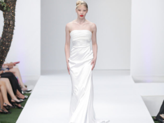 Modella con un abito lungo da sposa in raso bianco.