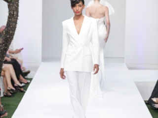 Modella con tailleur pantalone bianco e rossetto rosso.