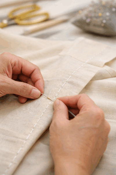 Hand sewing detail showing tailoring and fashion design fundamentals
